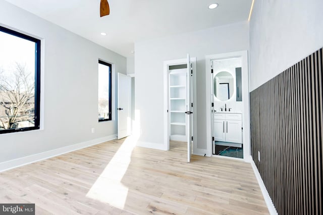 hall with sink and light hardwood / wood-style flooring