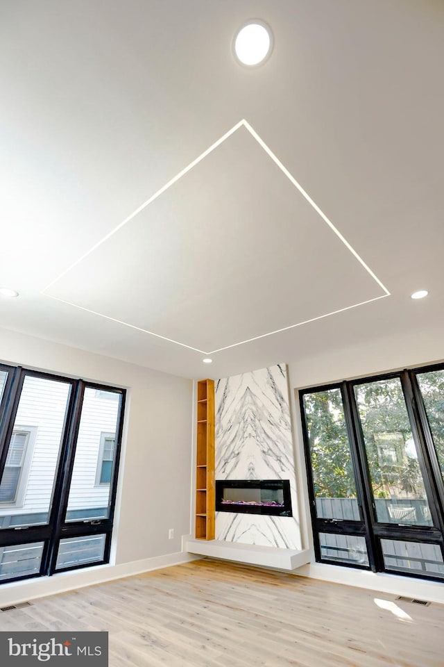 unfurnished living room with wood-type flooring