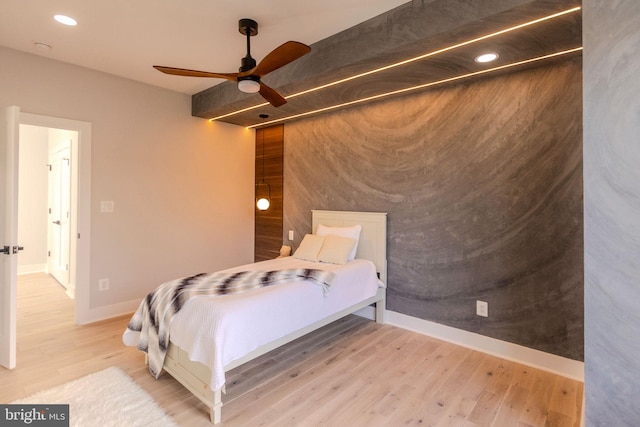 bedroom with hardwood / wood-style flooring and ceiling fan