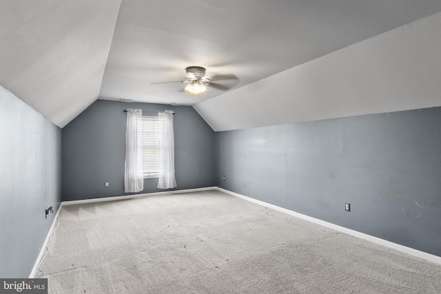 bonus room with vaulted ceiling, carpet, and ceiling fan