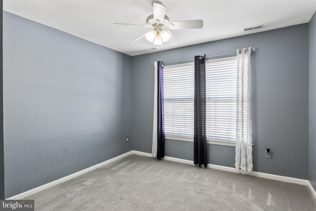 empty room featuring ceiling fan and light colored carpet