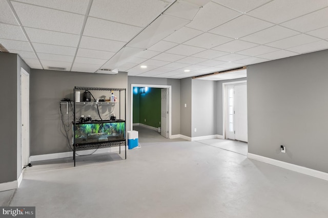 basement with a paneled ceiling