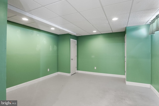 spare room featuring a drop ceiling and concrete flooring