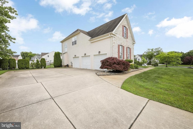 view of side of home with a garage and a yard