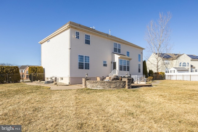 rear view of house featuring a yard