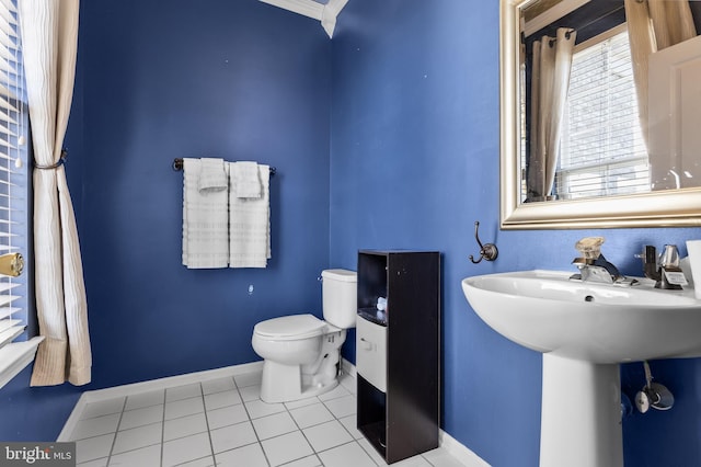 bathroom with ornamental molding, tile patterned floors, and toilet