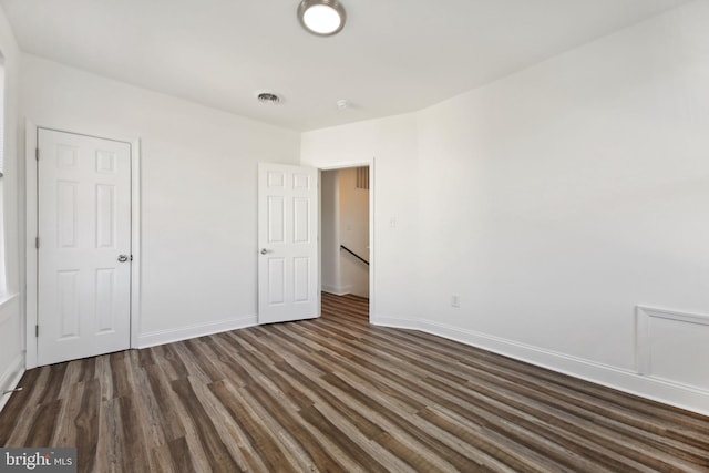 unfurnished bedroom featuring dark hardwood / wood-style flooring