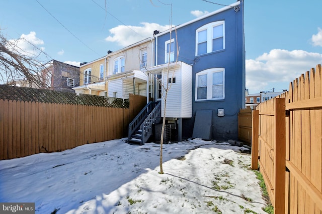 snow covered property featuring cooling unit