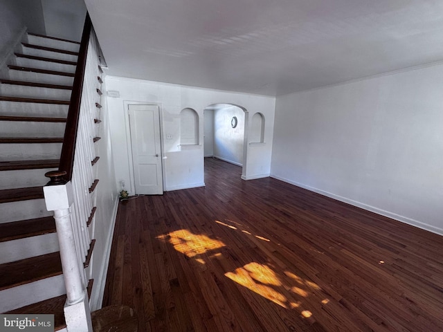 unfurnished living room with dark wood-type flooring