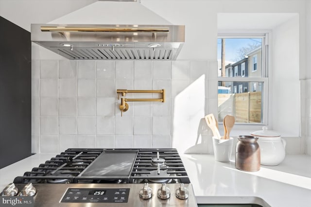 kitchen with ventilation hood, cooktop, and backsplash