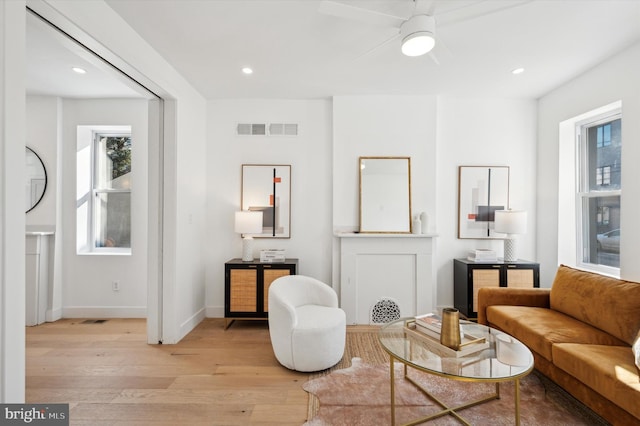 sitting room featuring ceiling fan and light hardwood / wood-style floors