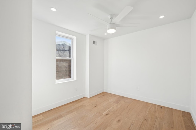 spare room with ceiling fan, light hardwood / wood-style flooring, and a healthy amount of sunlight