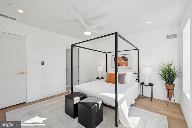 bedroom with ceiling fan and light hardwood / wood-style floors