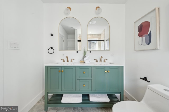 bathroom featuring toilet and vanity