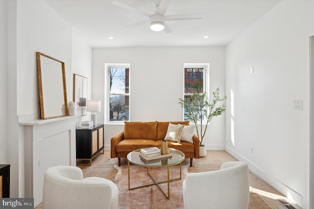 living room with light wood-type flooring and ceiling fan