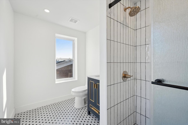 bathroom featuring toilet, walk in shower, and vanity