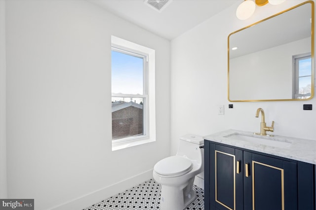 bathroom with toilet and vanity