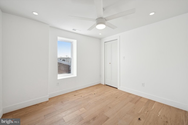 spare room with light hardwood / wood-style floors and ceiling fan