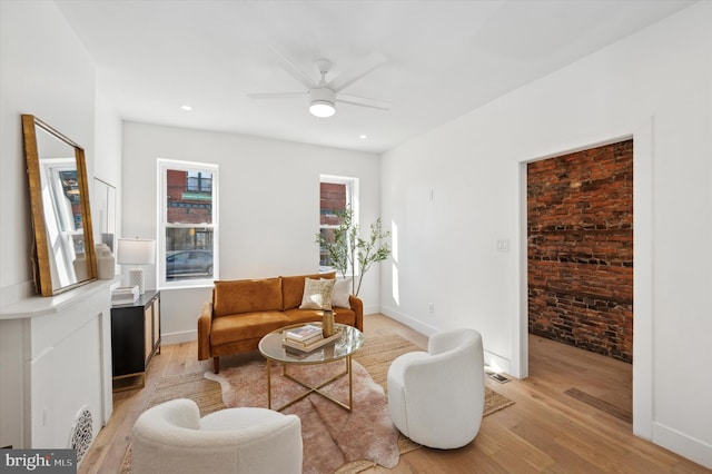 living room featuring ceiling fan and light hardwood / wood-style flooring