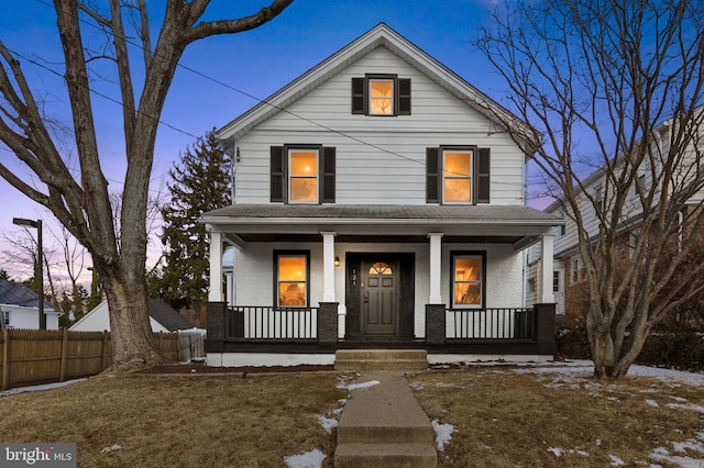 view of front facade featuring a porch and a lawn