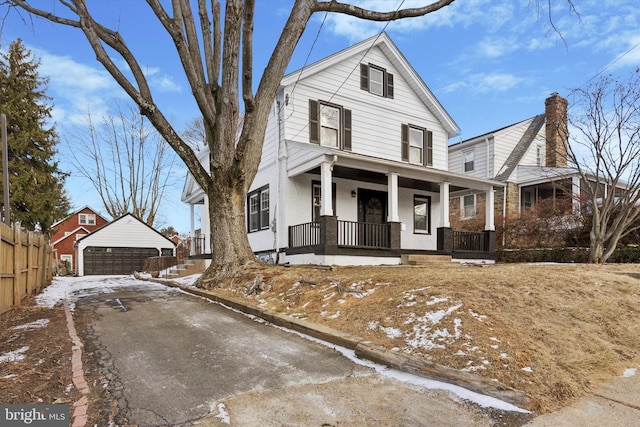 front of property with a porch, a garage, and an outdoor structure