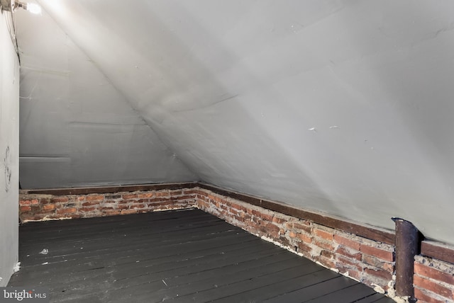 interior space with dark wood-type flooring and lofted ceiling