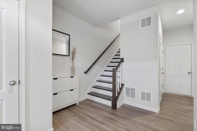 stairway with hardwood / wood-style floors