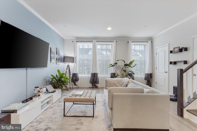 living room with ornamental molding and light wood-type flooring