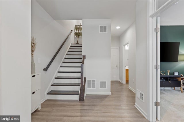 stairs with wood-type flooring