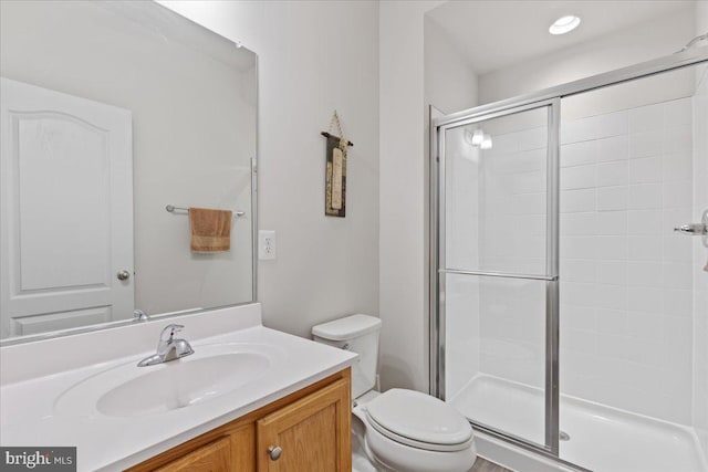 bathroom with vanity, toilet, and an enclosed shower