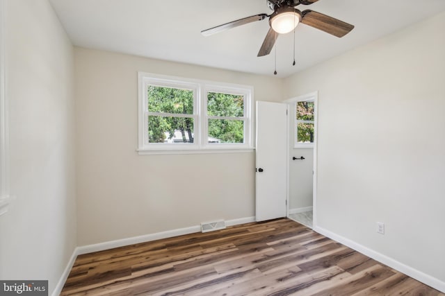 empty room featuring ceiling fan and hardwood / wood-style floors