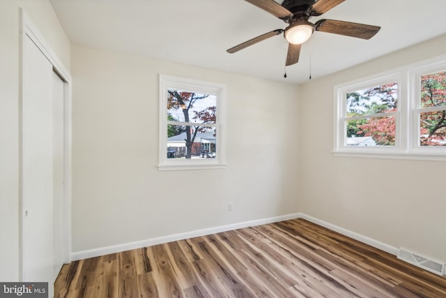 unfurnished bedroom with a closet, ceiling fan, and hardwood / wood-style flooring