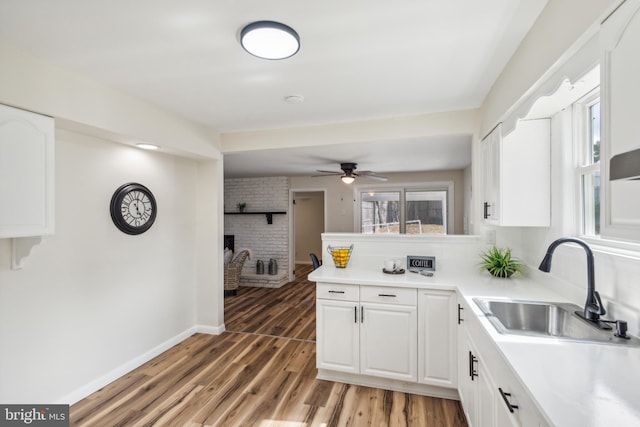 kitchen with sink, white cabinets, hardwood / wood-style floors, and ceiling fan