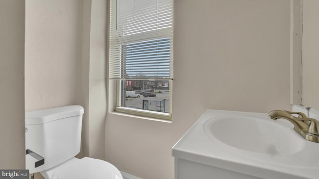 bathroom featuring toilet and vanity