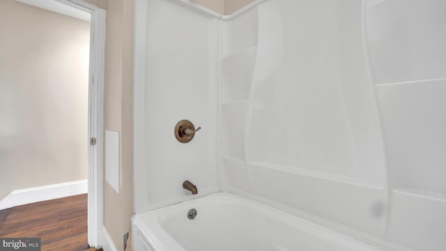 bathroom featuring bathtub / shower combination and hardwood / wood-style flooring