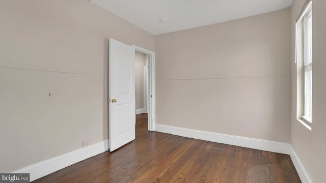 empty room featuring dark wood-type flooring