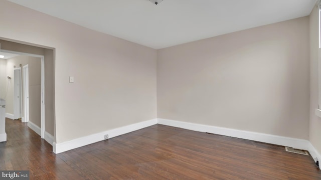 empty room with dark wood-type flooring