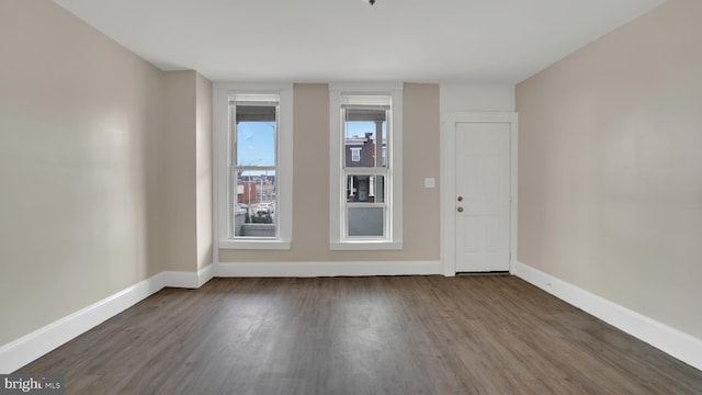 spare room with dark hardwood / wood-style flooring