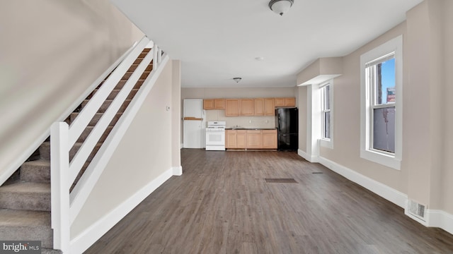 unfurnished living room featuring dark hardwood / wood-style flooring