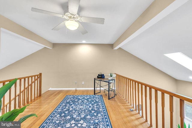 bonus room with ceiling fan, vaulted ceiling with beams, and wood-type flooring