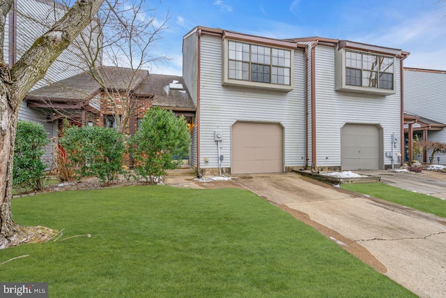 view of front facade with a front yard and a garage