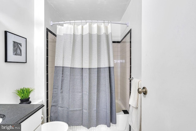 full bathroom with toilet, vanity, and shower / bath combo with shower curtain