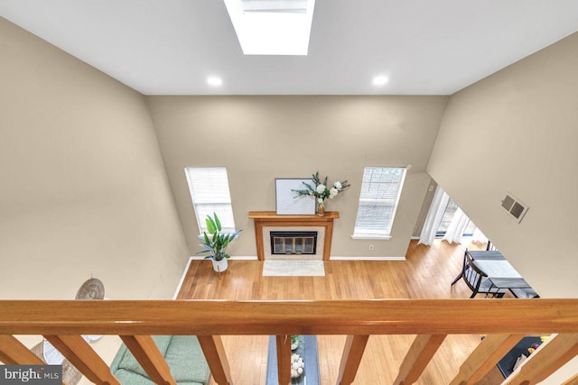 interior space featuring a skylight and hardwood / wood-style floors