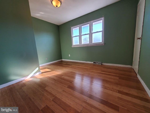 empty room with wood-type flooring