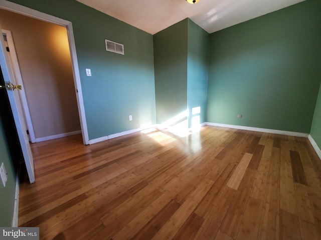 unfurnished room featuring hardwood / wood-style flooring