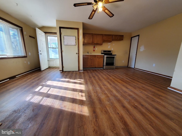 unfurnished living room with ceiling fan, dark wood-type flooring, vaulted ceiling, and sink