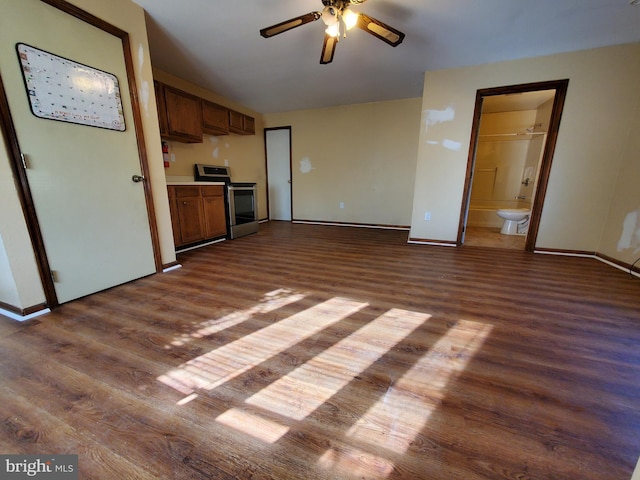 unfurnished living room featuring ceiling fan and dark hardwood / wood-style flooring