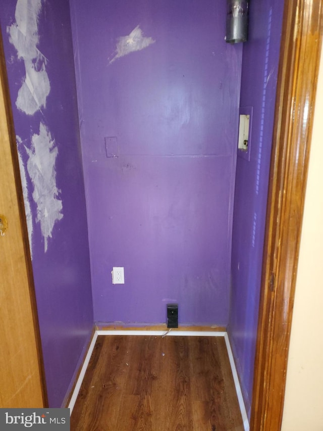 washroom with hardwood / wood-style floors and hookup for a washing machine