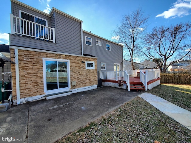 rear view of house featuring a deck