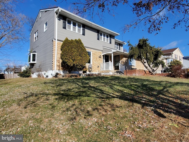 rear view of property with a yard and a porch